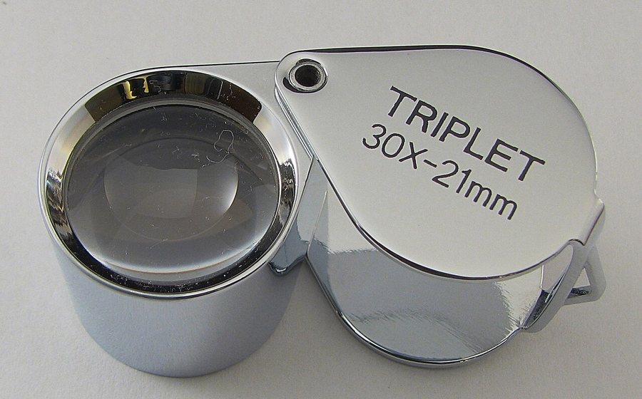 Jeweler's triplet loupe for gemstone inspection (representative photo)