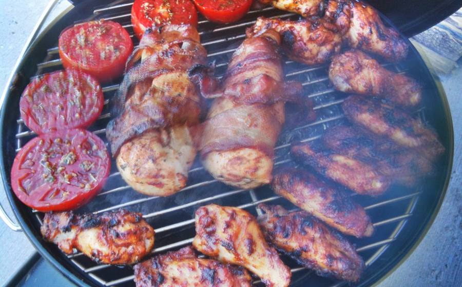 Chicken and tomatoes cooking on a compact portable grill (representative photo)